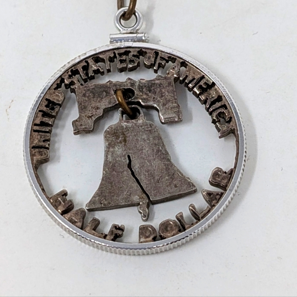 Vintage Liberty Bell Cut Out Half Dollar Necklace .